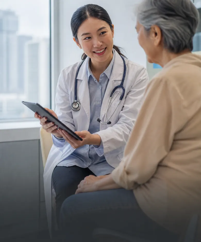 Doctor explaining results to an elderly patient on a tablet